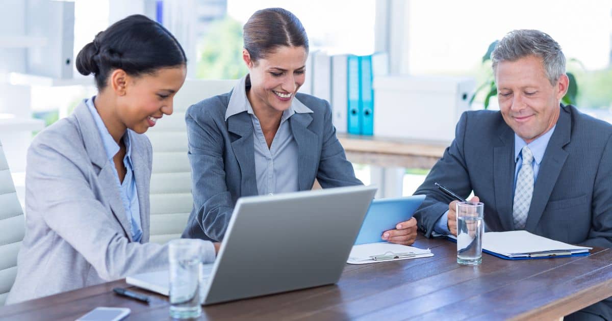 A diverse team of professionals discussing strategy, highlighting what executive search consultants do in a meeting.