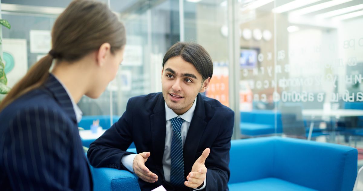 Business executives discussing C-Suite recruitment strategy in a modern office meeting setting