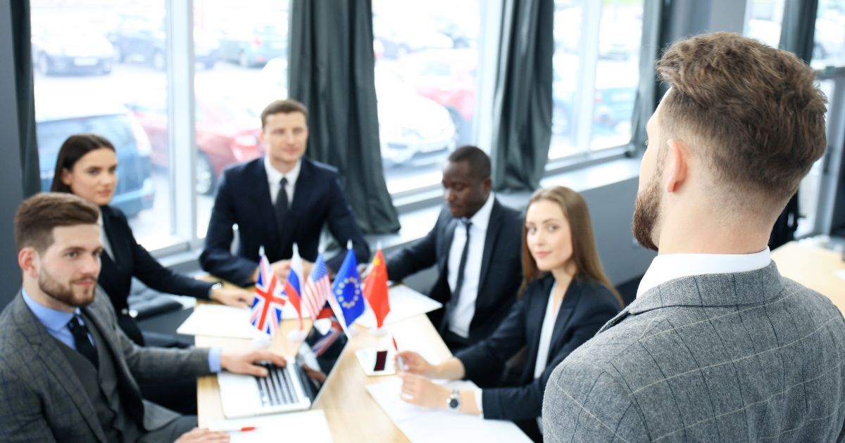 Executive level recruitment discussion with international business leaders in a corporate meeting setting