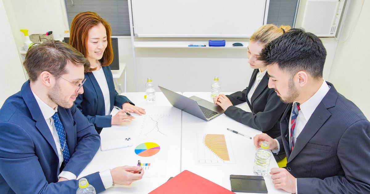 Executive search team reviewing charts and planning leadership hiring strategy in meeting