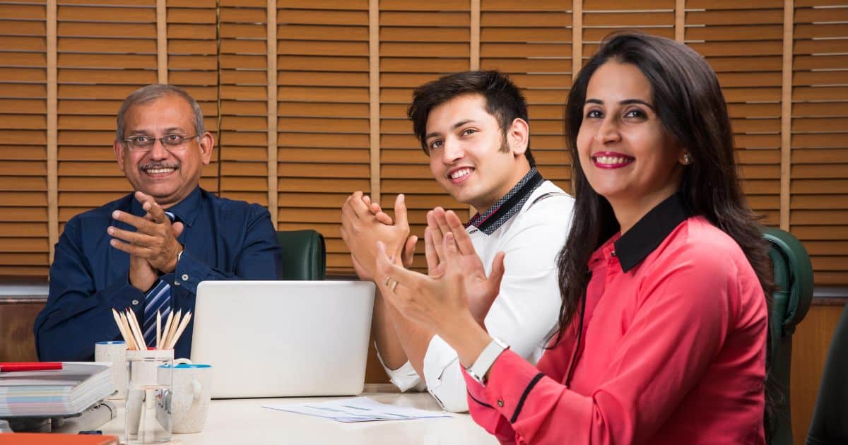 Three professionals having a strategic discussion in a corporate setting, representing an Executive Search Firm.