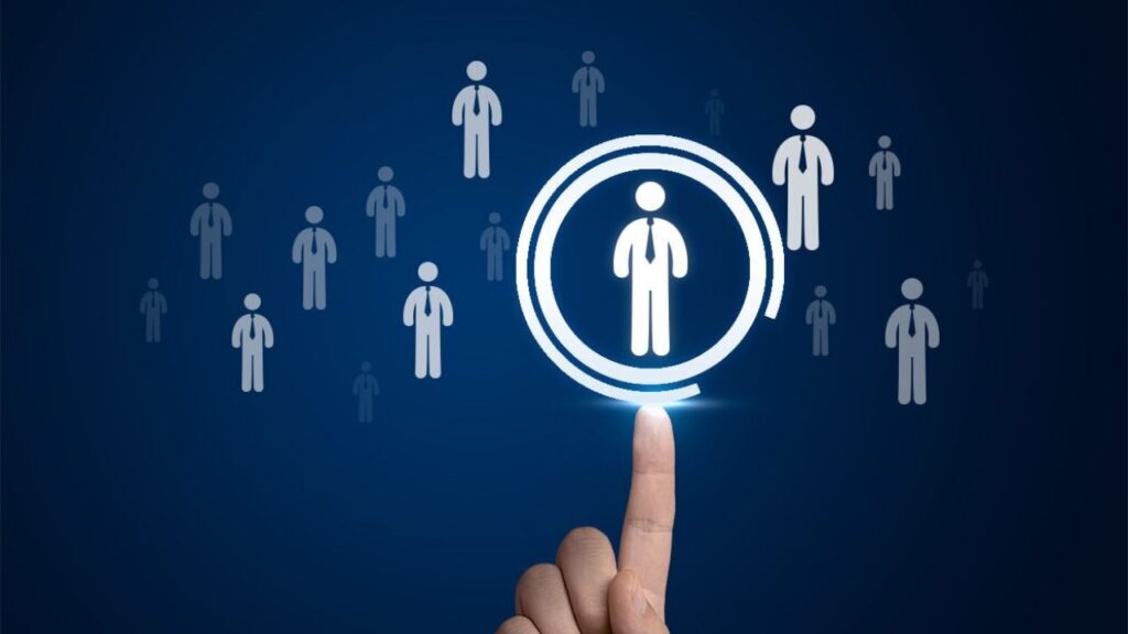 Hand selecting a standout candidate icon from a group, symbolizing executive search firm talent identification.