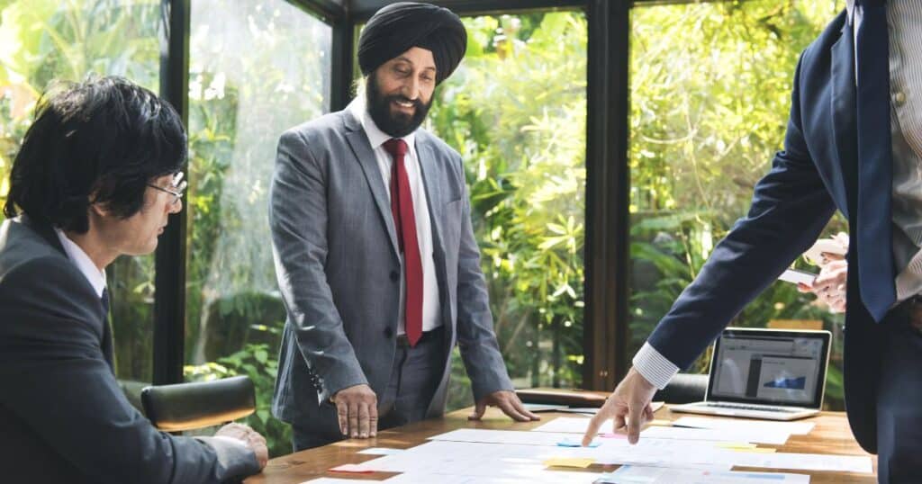 Professional business meeting at an executive search firm discussing leadership hiring strategies.