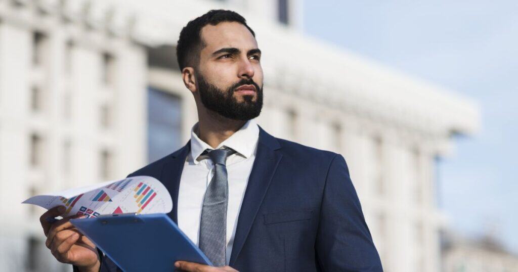 Two professionals in a business meeting discussing FMCG & Durable Goods Recruitment strategies at a modern office.